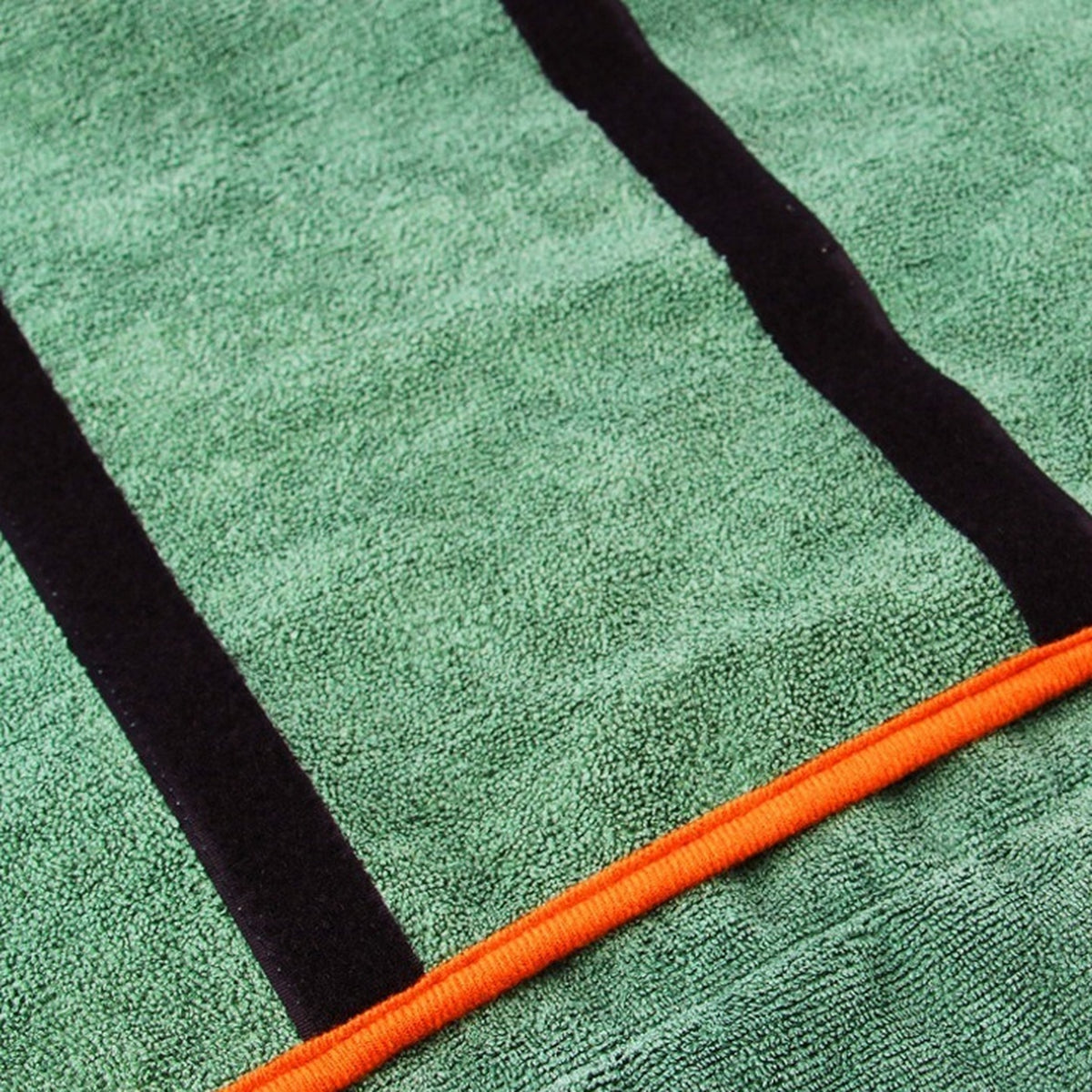 Close-up of the Microfiber Drying Robe's green microfiber, black fastening straps and orange trim